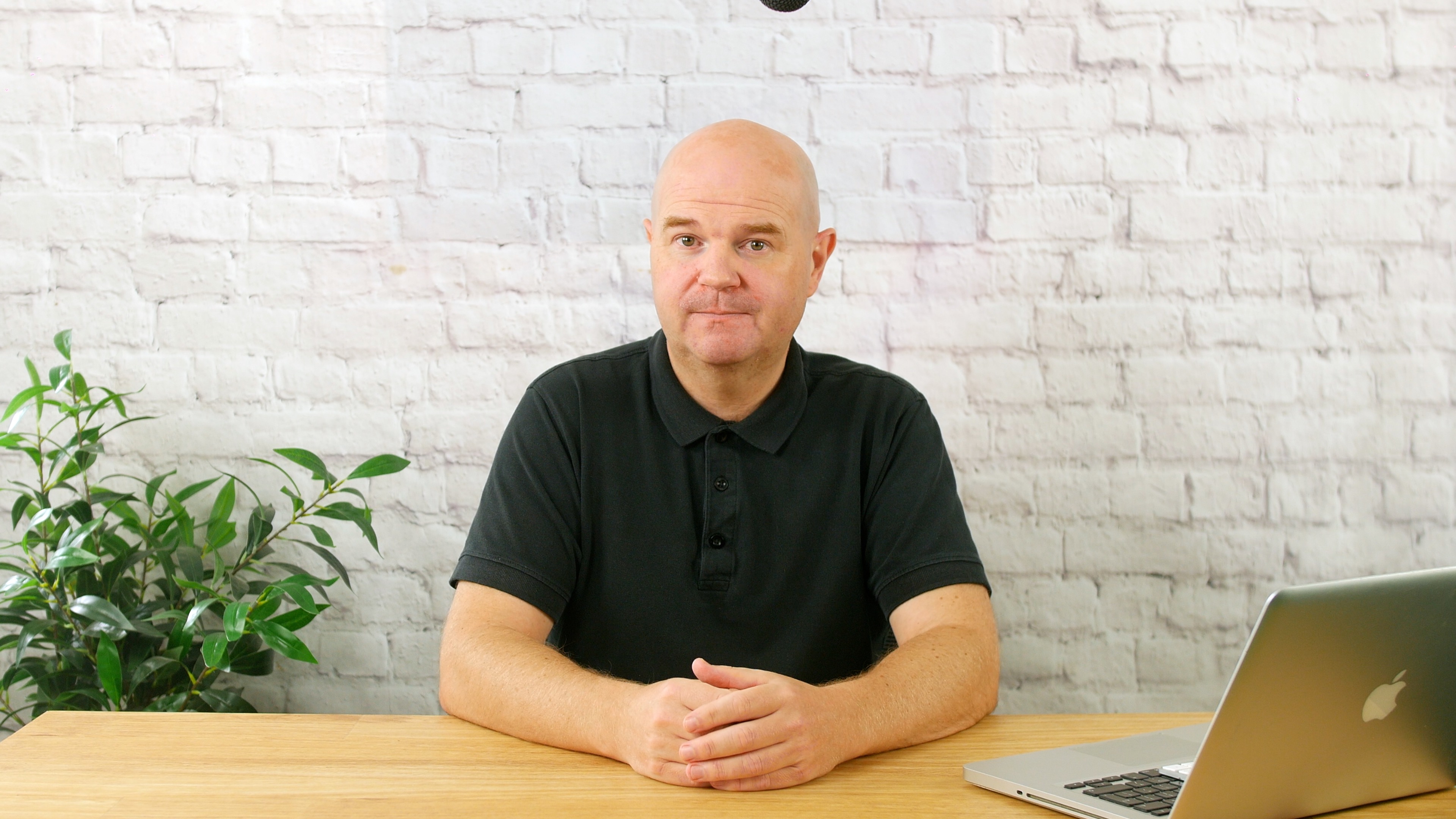 Screen Promos founder sitting at a desk
